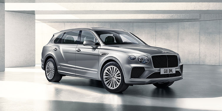 Bentley Tallinn Bentley Bentayga Extended Wheelbase SUV front three quarter in Moonbeam paint with a grey background