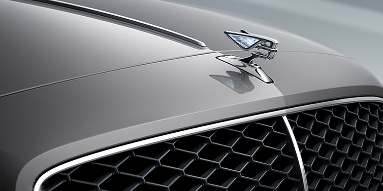 Bentley Tallinn New Bentley Flying Spur sedan bonnet detail in Silverlake paint with Illuminated Flying B bonnet badge and matrix grille with chrome surround