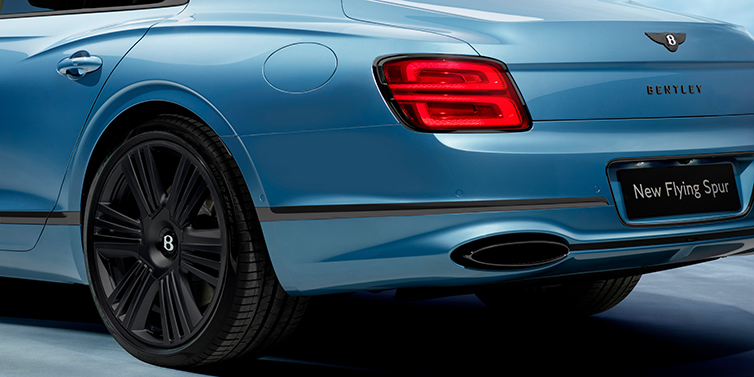 Bentley Tallinn New Bentley Flying Spur Azure sedan in Light windsor blue by Mulliner paint and Black Specification, showing 22 inch Black Azure wheel, black exhaust pipes and exterior features