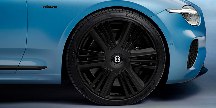 Bentley Tallinn New Bentley Continental GTC Azure convertible front wheel detail with 22 inch black ten spoke wheel and dark chrome details against Light Windsor blue paint