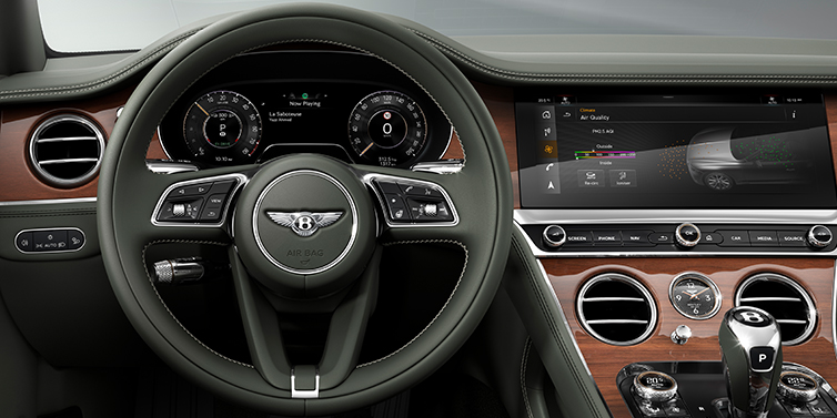 Bentley Tallinn New Bentley Continental GT coupe steering wheel and front cabin view in Cumbrian Green hide and Crown Cut walnut veneer